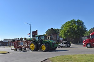 A tractor rolls down the business district of Colby, Kansas by Kathy Weiser-Alexander.