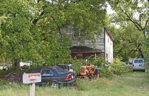 An old house and junk in Bridgeport, Kansas by Kathy Alexander.