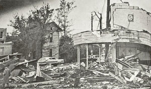 The tornado came closest to the ground on South Sixth Street. Following the storm, the local Buick Dealership lies under a pile of rubble.