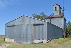 Grain elevator and farm storage in Densmore, Kansas by Kathy Alexander.