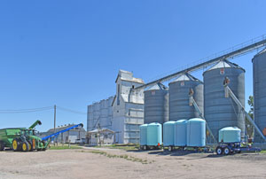 Silos and grain elevator in Ludell, Kansas by Kathy Alexander.