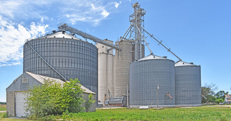 Grain elevators and silos in Asherville, Kansas by Kathy Alexander.