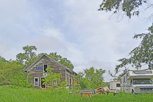 And old building and junk in Oneida, Kansas by Kathy Alexander.